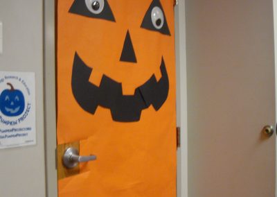 Picture of door decorated as a large pumpkin
