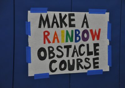 Sign saying "Make a rainbow obstacle course"